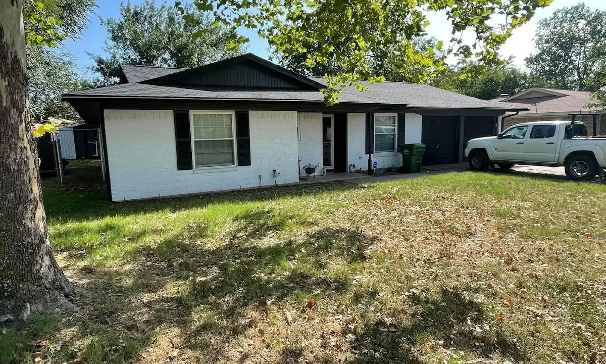 Professional roofing crew working on a residential roof in Stamford